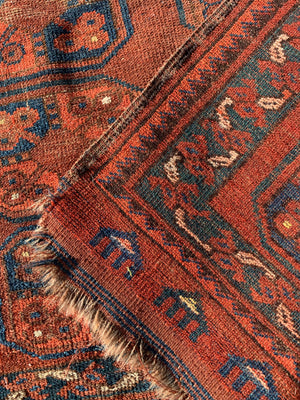 A Persian brown ground rectangular Bokhara rug