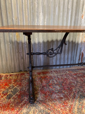 A Victorian cast iron refectory table with wooden top by Thomas Green and Son