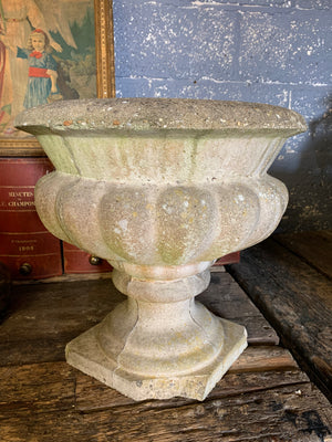 A pair of large cast stone gadrooned urns
