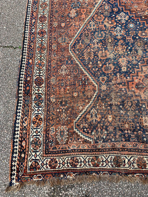 A very large hand woven Persian blue and orange rectangular rug- 300cm x 225cm