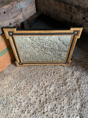 A black and gilt outset or box corner mirror