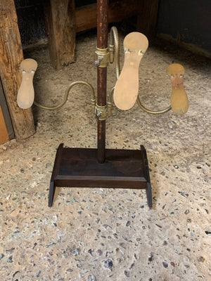 A wood and brass shoe shop display stand by Potter