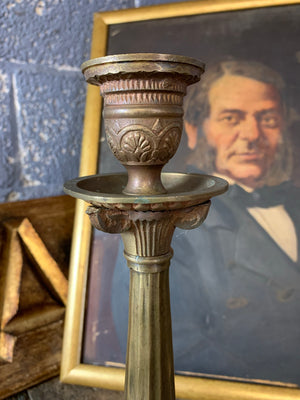 A pair of gothic lion paw candlesticks