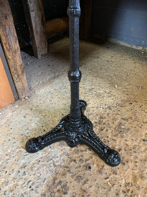 A black cast iron bistro table with marble top 1/3