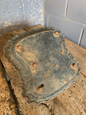 A black cast iron boot scraper