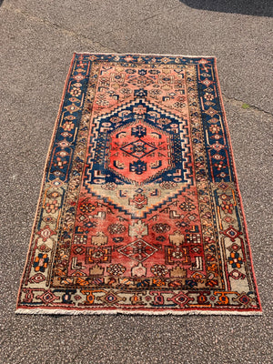 A rectangular red brown ground Persian rug