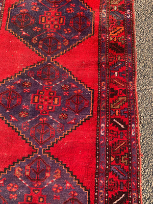 A red ground runner rug - 207cm x 108cm