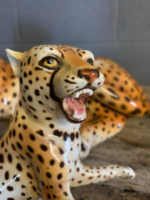 A ceramic mid-century cheetah and cubs statue set
