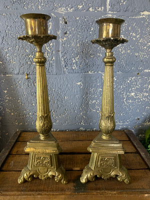 A large pair of heavy brass church candlesticks