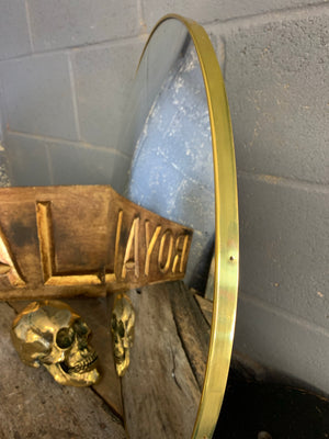 A large gold convex mirror