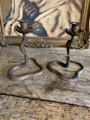 A pair of Indian or North African cobra candlesticks