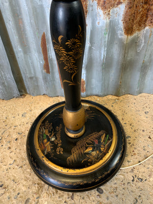 A black lacquer chinoiserie standard lamp with pagoda shade