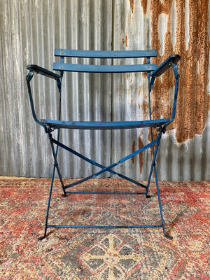 A blue cast iron French garden table and two chairs