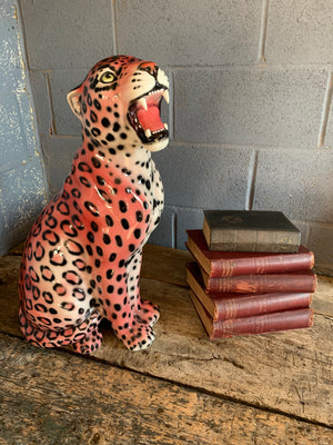 A large pink ceramic leopard statue made in Italy