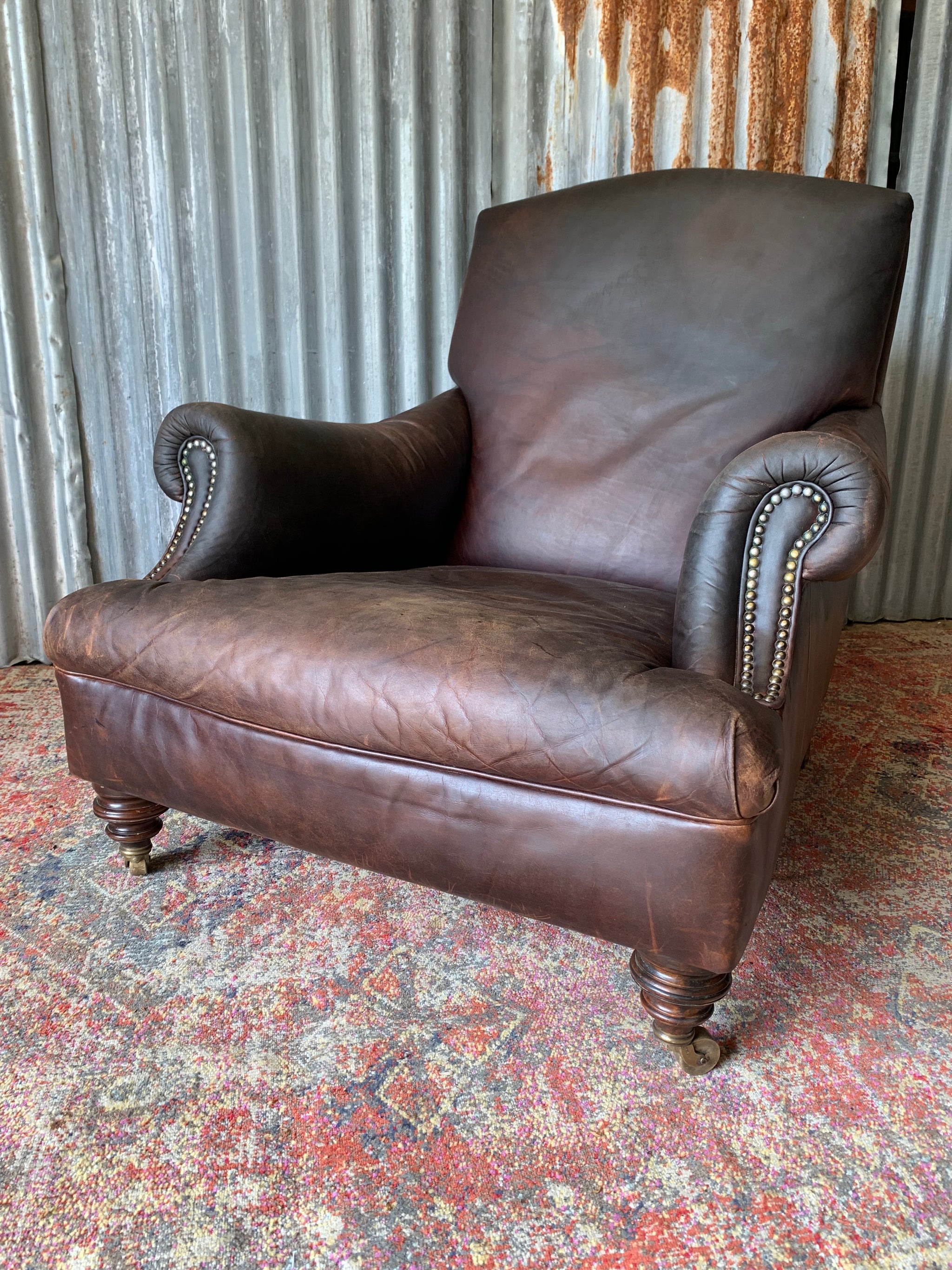 A deep leather armchair raised on castors Belle and Beast Emporium