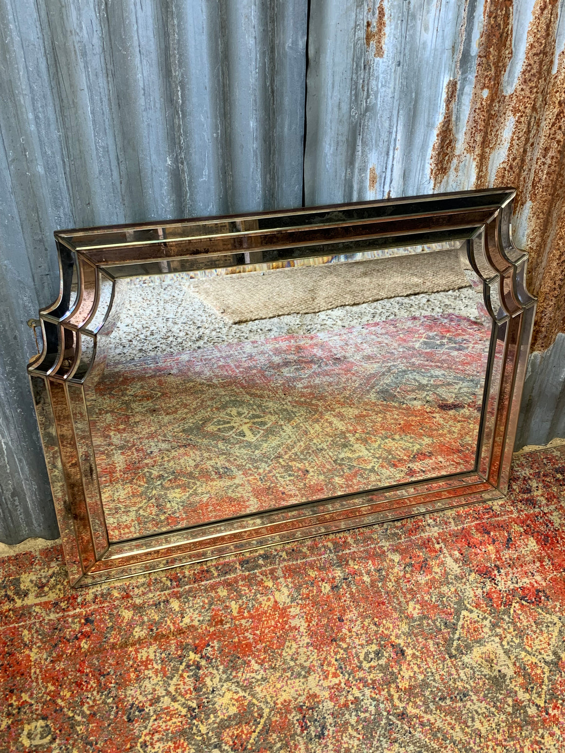 A large Art Deco scalloped frameless mirror