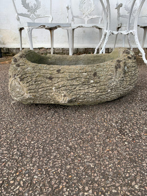 A pair of cast stone faux bois trough planters