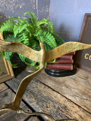 A trio of gilded bronze flocks of birds in flight