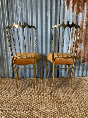 A pair of brass Chiavari chairs