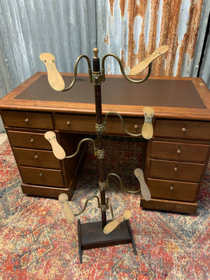 A wood and brass shoe shop display stand by Potter