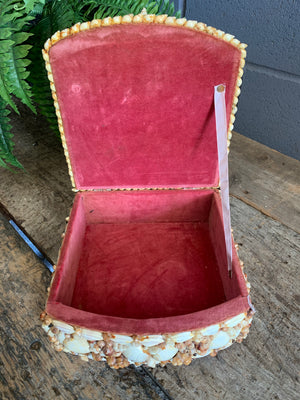 A very large seashell encrusted trinket box