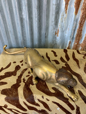 A brass prowling leopard statue