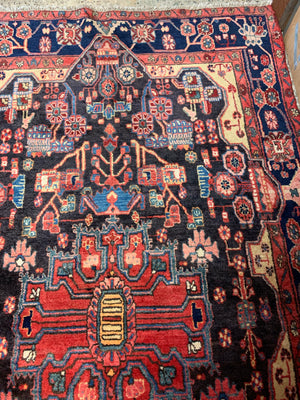 A very large rectangular red ground Persian rug