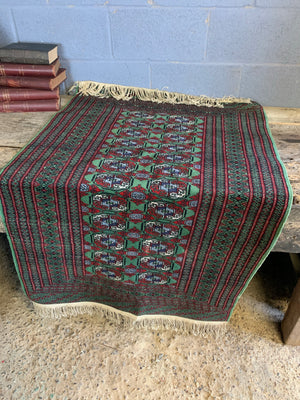 A Persian Bokhara rectangular rug - red/green tones