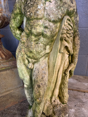 A weathered statue of Hercules