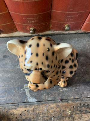 A ceramic mid-century leopard cub statue
