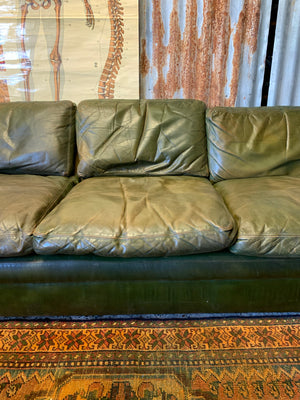 A large 3 seater Modernist Italian sofa in green leather of boat or 'egg' form