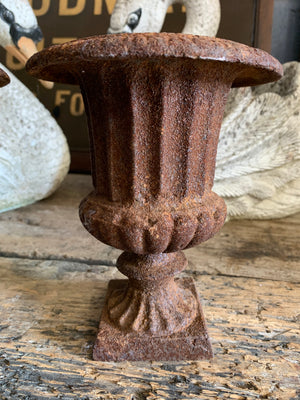 A pair of small cast iron campana urns