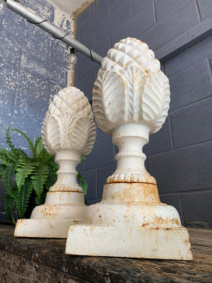 A pair of white cast iron acorn or pineapple finials