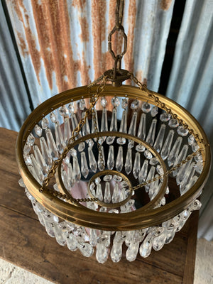 A gilt three tier crystal icicle droplet chandelier
