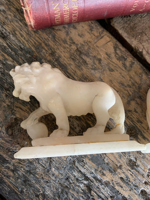 An opposing pair of Grand Tour alabaster Medici lions