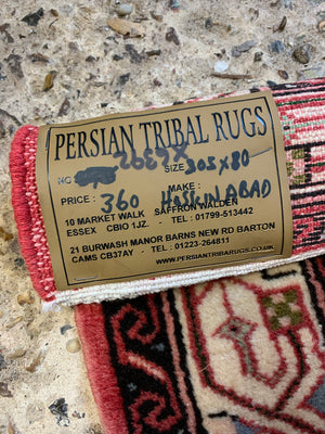 A long pink and red ground Persian Hosseinabad runner rug