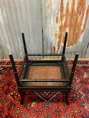 An ebonised faux bamboo cane stool