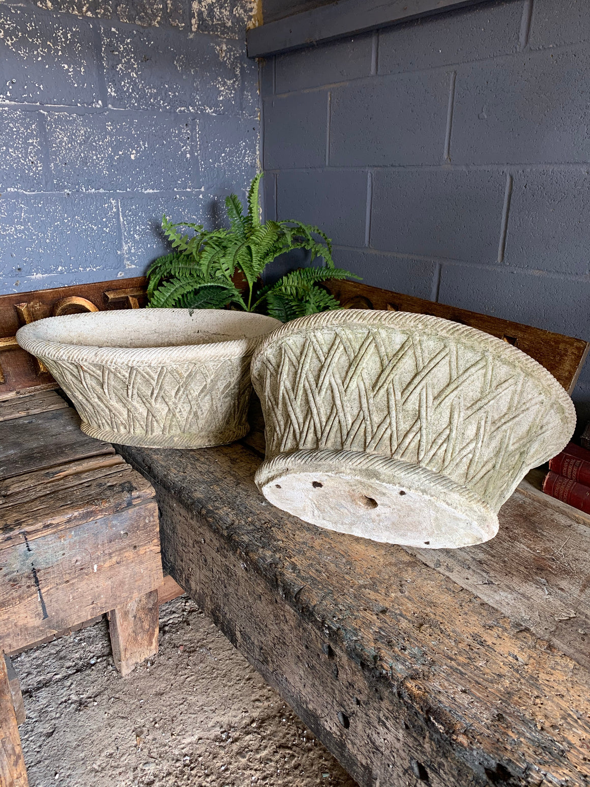 A pair of large oval lattice cast stone urns