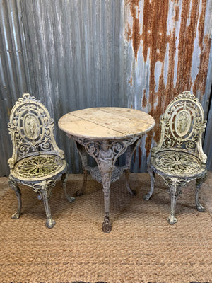 A white cast iron Britannia Abolitionist garden table with 2 chairs