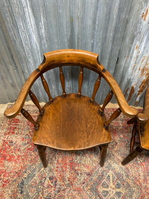 A pair of bow back captain's chairs