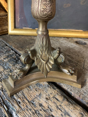 A pair of gothic lion paw candlesticks