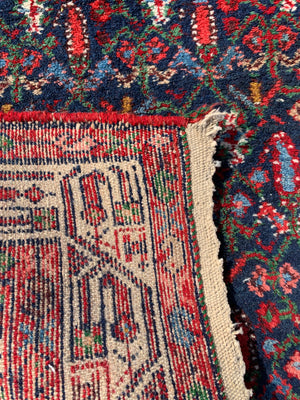 A large blue lozenge Persian rug - 181cm x 105cm