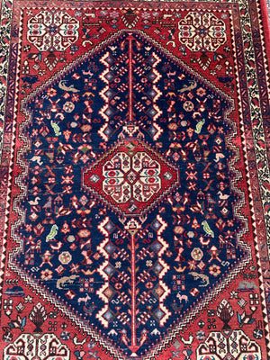 A red ground animal motif Persian rectangular rug 156cm x 105cm