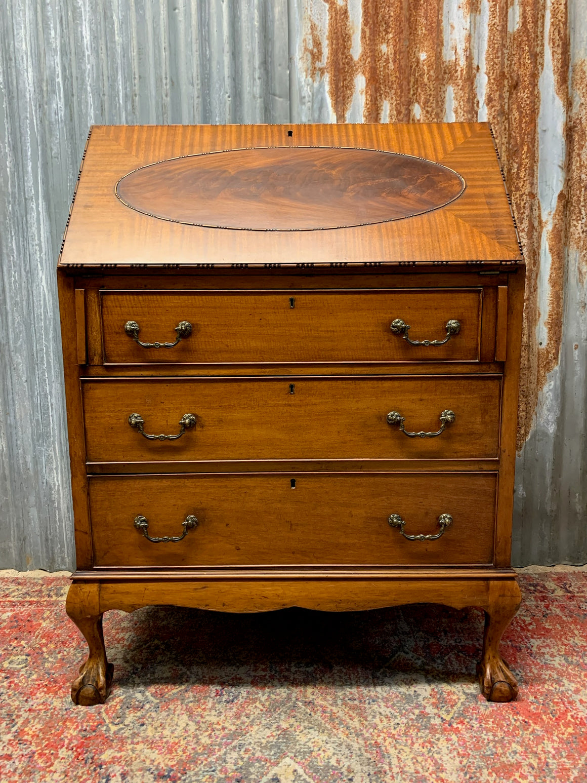 A Victorian style bureau with ball and claw feet