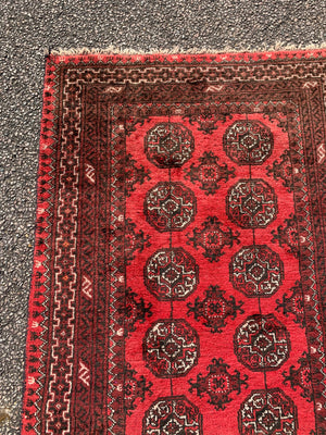 A red ground Bokhara rectangular rug- 180cm x 100cm