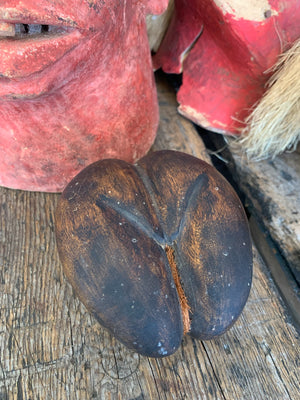 A carved wooden coco de mer specimen