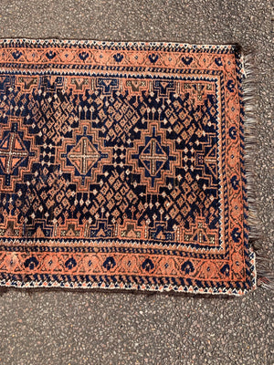 A orange blue ground Persian rectangular rug 129cm x 79cm