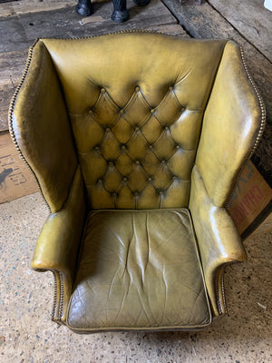 An apple-green wingback Chesterfield chair