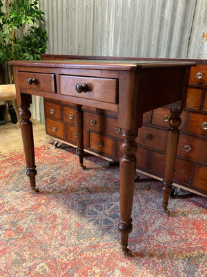 A Victorian mahogany writing desk with green leather top