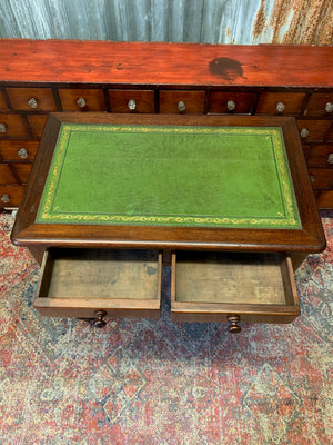 A Victorian mahogany writing desk with green leather top